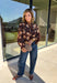 Bring a fresh twist to your fall wardrobe with this beautifully detailed blouse from Fate. Featuring a rich brown leopard-inspired print accented with a soft neutral floral design, this feminine top effortlessly blends bold style with timeless charm. The button-front silhouette is finished with a subtle ruffle neckline and delicate ruffle details throughout the front and back for added texture. 