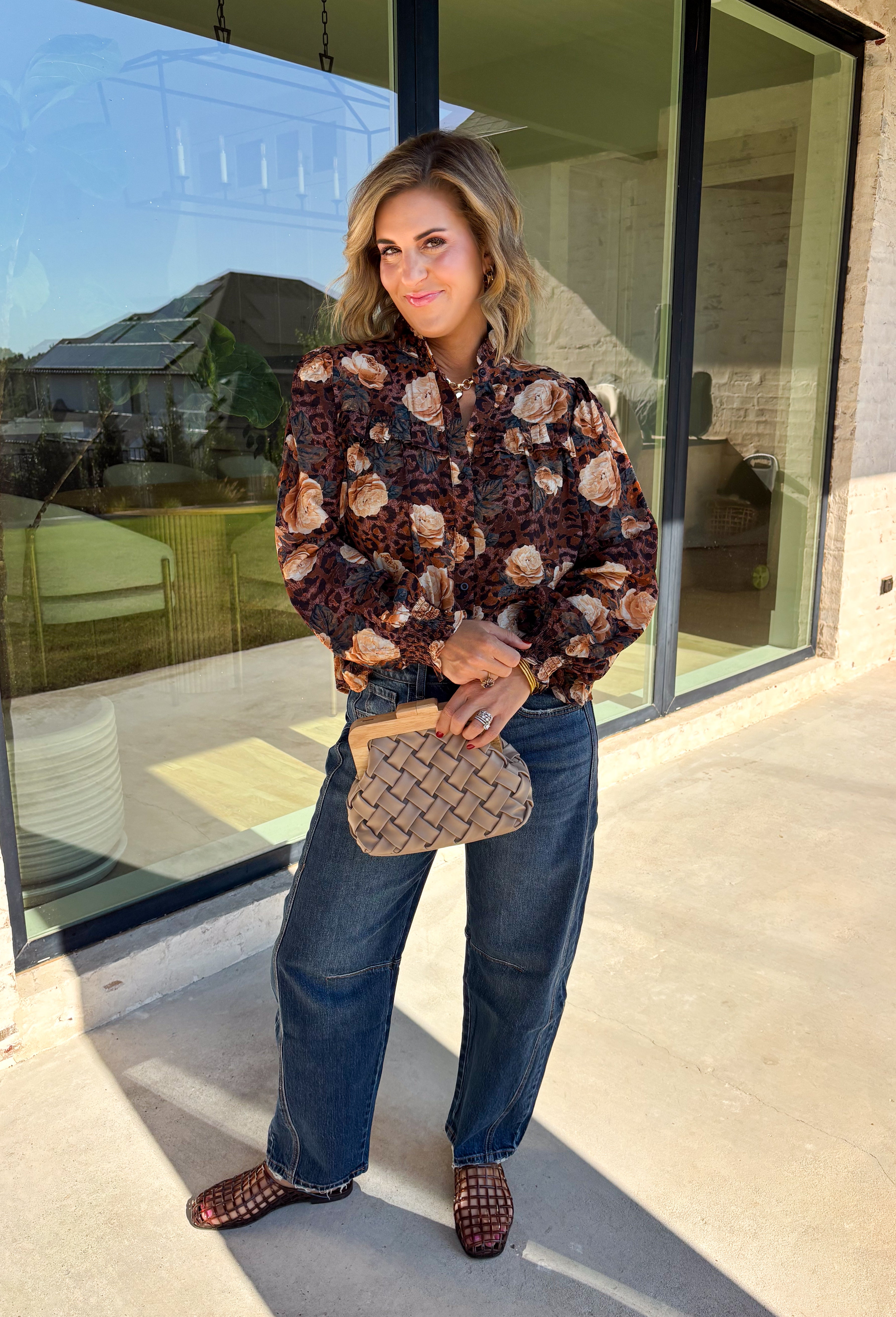 Bring a fresh twist to your fall wardrobe with this beautifully detailed blouse from Fate. Featuring a rich brown leopard-inspired print accented with a soft neutral floral design, this feminine top effortlessly blends bold style with timeless charm. The button-front silhouette is finished with a subtle ruffle neckline and delicate ruffle details throughout the front and back for added texture. 