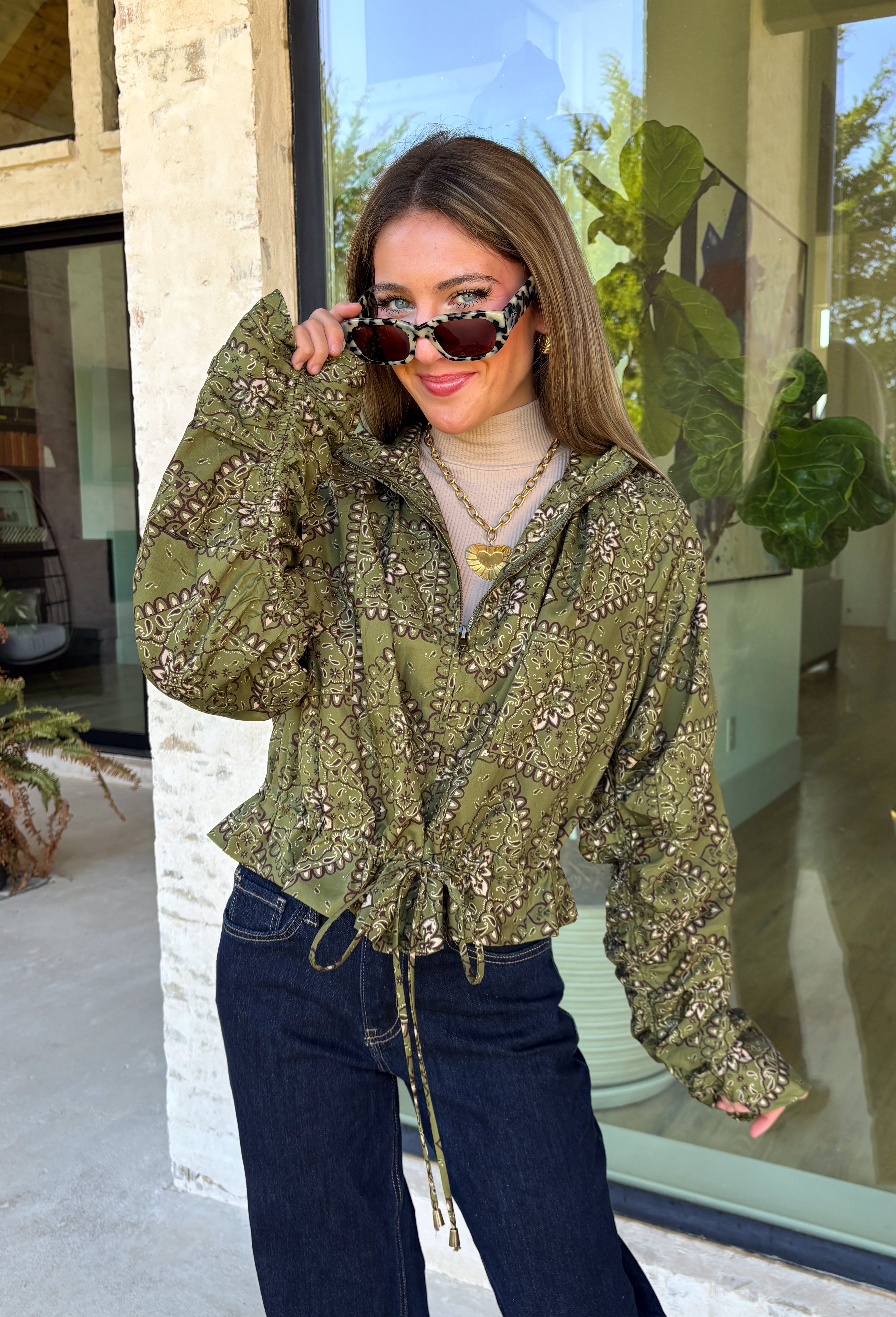 Give your everyday layers a western-inspired twist with this olive bandana jacket from Entro. The rich olive color paired with the bandana-inspired print gives it a vintage feel that's fun without being hard to style. A zipper-front closure keeps the look casual and easy to throw on, while convenient side pockets add an everyday touch you'll appreciate. Made from 100% cotton, it's a great lightweight layer to keep nearby for crisp mornings, weekend errands, and casual nights out. 