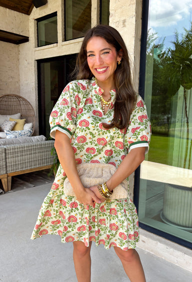 This neutral floral dress is such a fresh and fun pick for summer! With pops of green, pink, red, yellow, and orange, it brings just the right amount of color while still feeling easy to wear for everyday plans. The green and white trim on the sleeves adds a playful contrast, and the subtle ruffle neckline gives it a soft, feminine touch. Lightweight, fully lined, and finished with side pockets (always a win), it’s perfect for everything from brunch to weekend outings. 