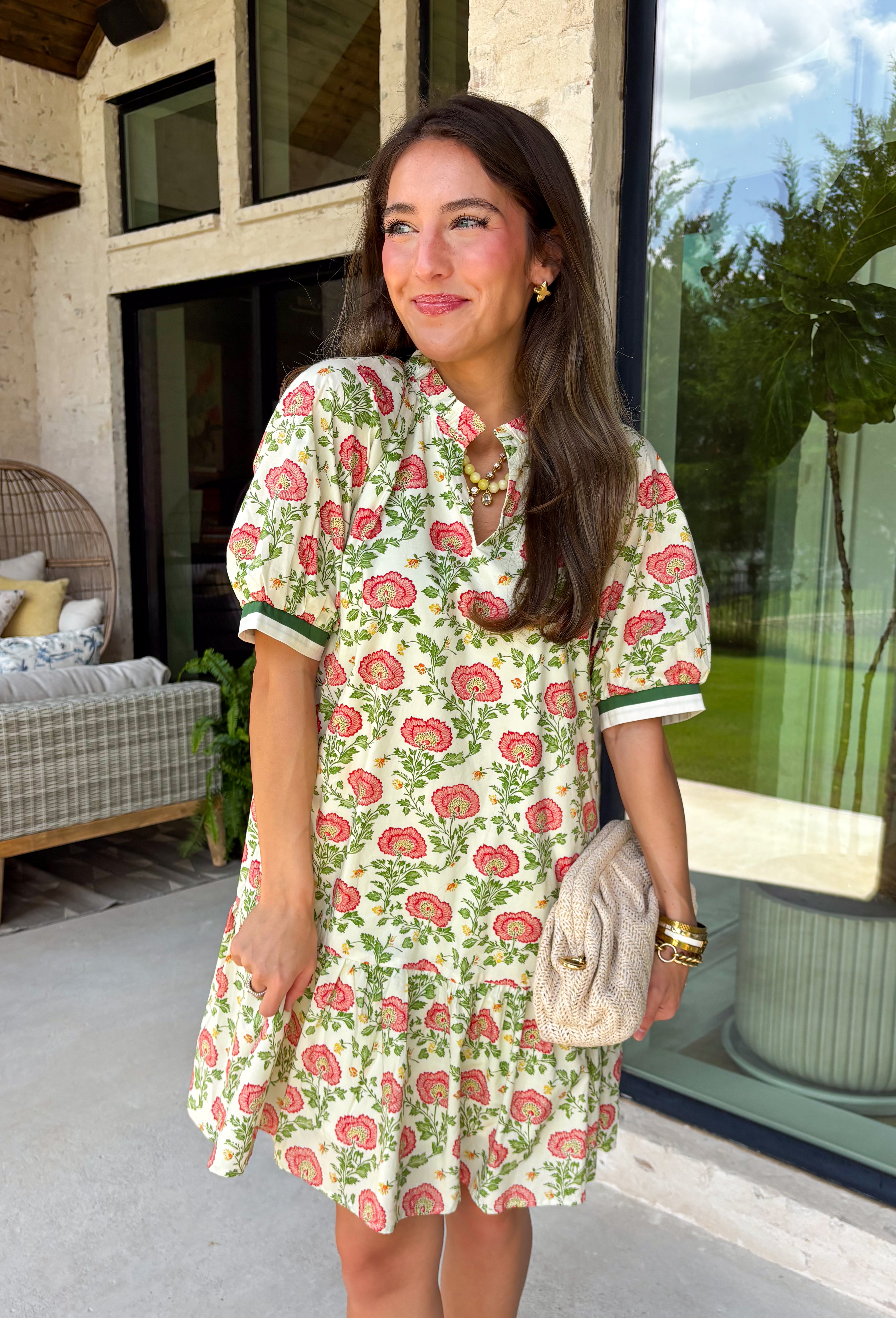 This neutral floral dress is such a fresh and fun pick for summer! With pops of green, pink, red, yellow, and orange, it brings just the right amount of color while still feeling easy to wear for everyday plans. The green and white trim on the sleeves adds a playful contrast, and the subtle ruffle neckline gives it a soft, feminine touch. Lightweight, fully lined, and finished with side pockets (always a win), it’s perfect for everything from brunch to weekend outings. 