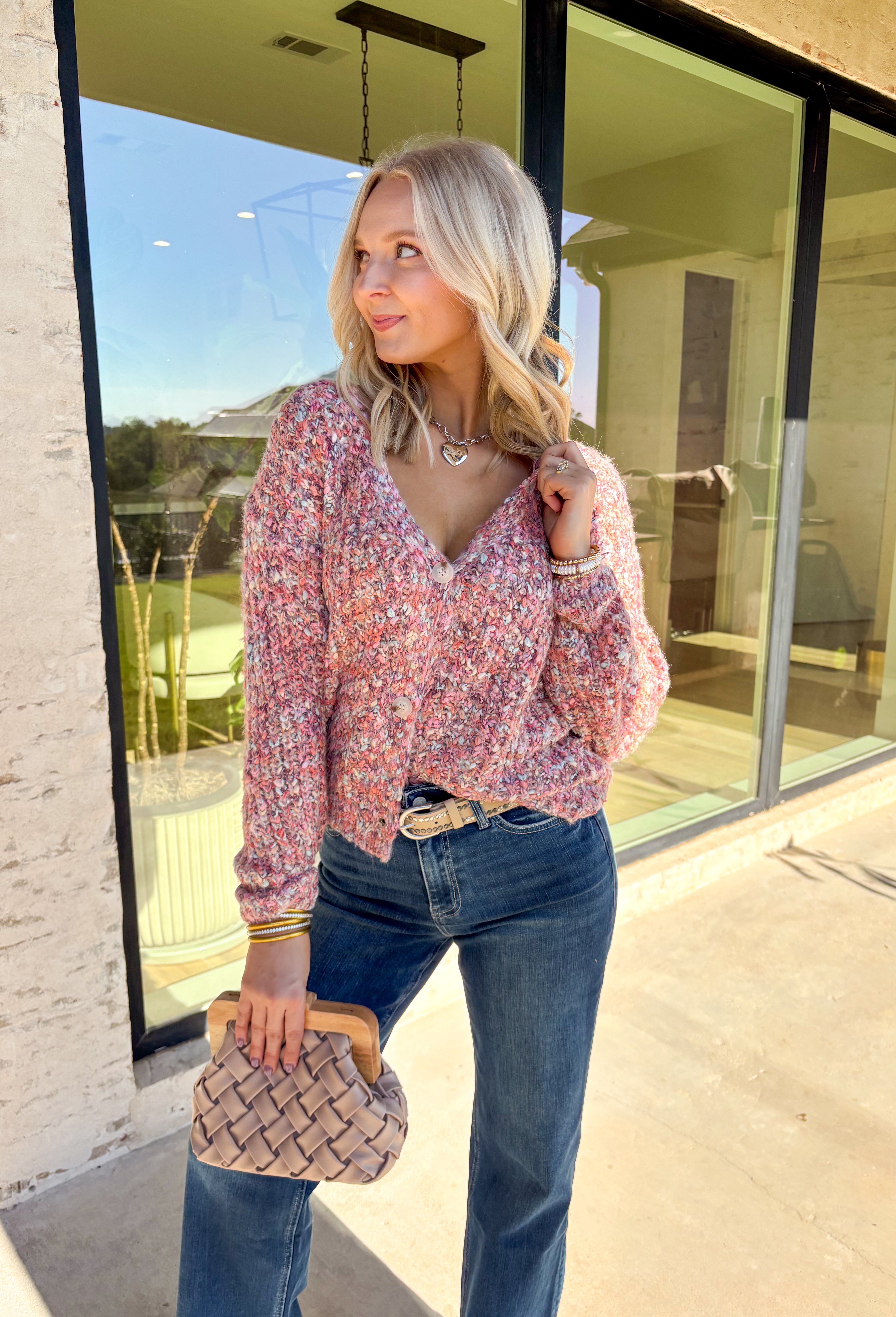 This cozy knit cardigan by Mystree brings warmth and color to your fall wardrobe. Designed in shades of pink, purple, light blue, and cream, it’s finished with a button-down front that makes it easy to style open or closed. Soft with a touch of wool, this piece has that perfect blend of comfort and charm—ideal for layering on crisp days.