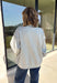 Show a little Lone Star love while staying extra cozy in this heather grey “Texas” pullover from Bucket List. The bold lettering features a crimson and white stripe print, with each letter outlined in white embroidery for added texture and a standout finish. A mock neckline and long sleeves give it a cozy cold-weather feel, while the fleece-lined interior makes it perfect for crisp fall mornings and chilly weekends. 