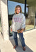 Show a little Lone Star love while staying extra cozy in this heather grey “Texas” pullover from Bucket List. The bold lettering features a crimson and white stripe print, with each letter outlined in white embroidery for added texture and a standout finish. A mock neckline and long sleeves give it a cozy cold-weather feel, while the fleece-lined interior makes it perfect for crisp fall mornings and chilly weekends. 