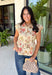 Fresh florals meet cozy fall style in this charming peplum blouse. Featuring a soft neutral backdrop with delicate pops of pink and green, this top brings just the right amount of color to your autumn wardrobe. The collared neckline and button front add a timeless, polished touch, while the peplum hem creates a flattering silhouette you'll love. Elastic puff sleeves complete the look with feminine charm, making this top perfect for everything from workdays to weekend brunches.