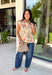 Fresh florals meet cozy fall style in this charming peplum blouse. Featuring a soft neutral backdrop with delicate pops of pink and green, this top brings just the right amount of color to your autumn wardrobe. The collared neckline and button front add a timeless, polished touch, while the peplum hem creates a flattering silhouette you'll love. Elastic puff sleeves complete the look with feminine charm, making this top perfect for everything from workdays to weekend brunches.