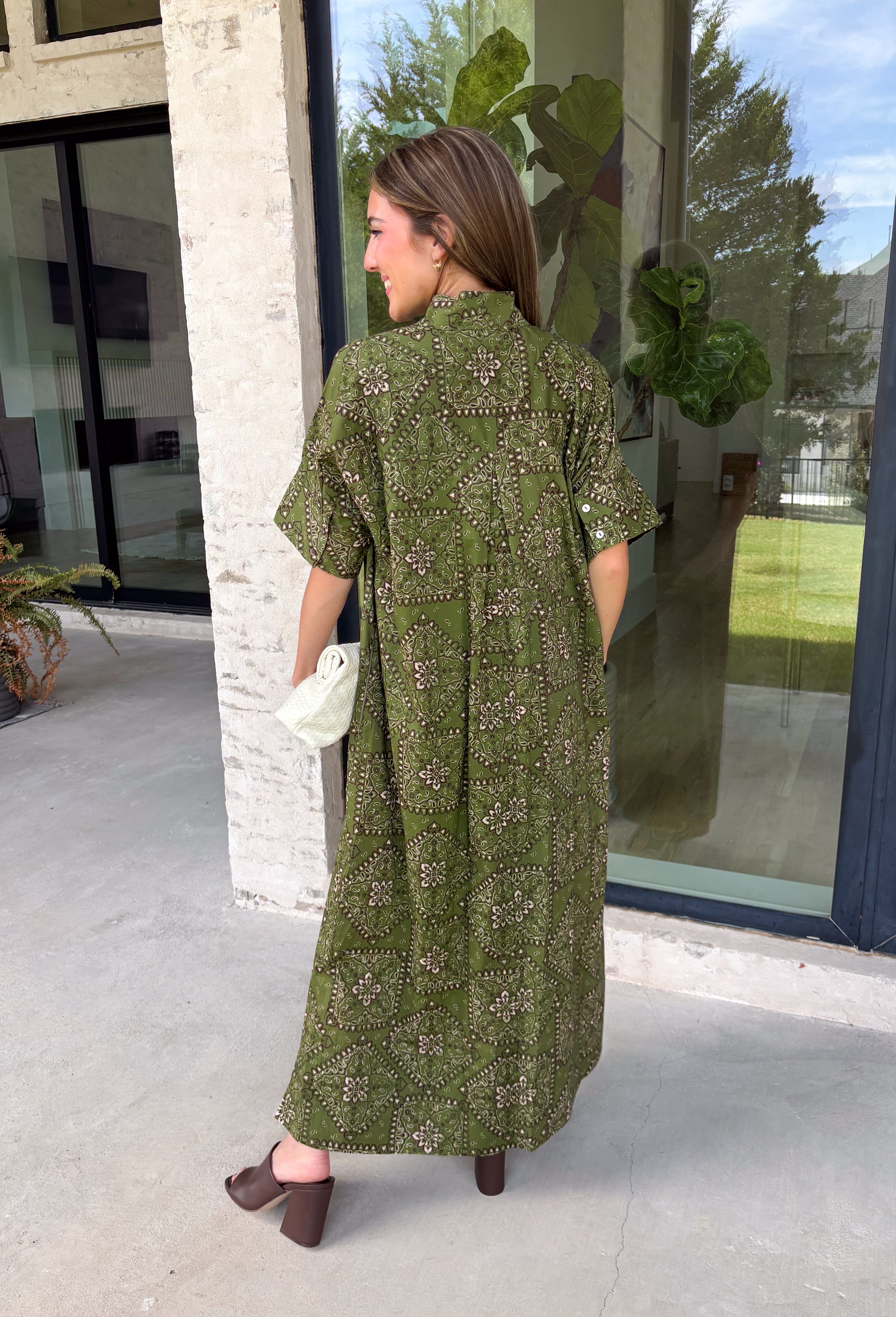 Embrace effortless fall style with this beautifully detailed midi dress from Entro. Designed in a rich olive hue with a vintage-inspired paisley print in shades of brown and off-white, this timeless dress brings the perfect blend of western charm and boho flair. The flattering midi silhouette is easy to dress up or down, while convenient side pockets add an everyday touch you'll love. 