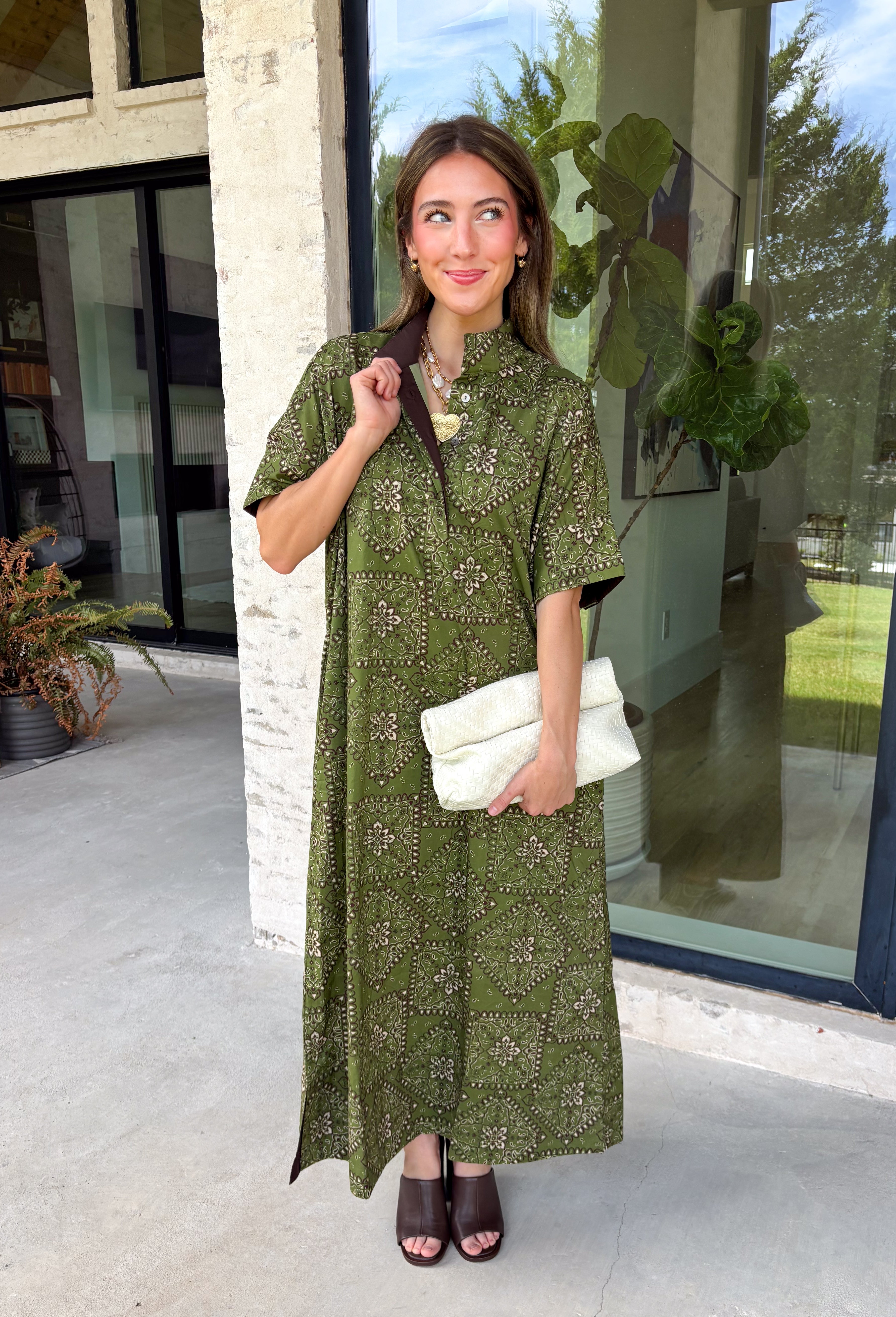Embrace effortless fall style with this beautifully detailed midi dress from Entro. Designed in a rich olive hue with a vintage-inspired paisley print in shades of brown and off-white, this timeless dress brings the perfect blend of western charm and boho flair. The flattering midi silhouette is easy to dress up or down, while convenient side pockets add an everyday touch you'll love. 