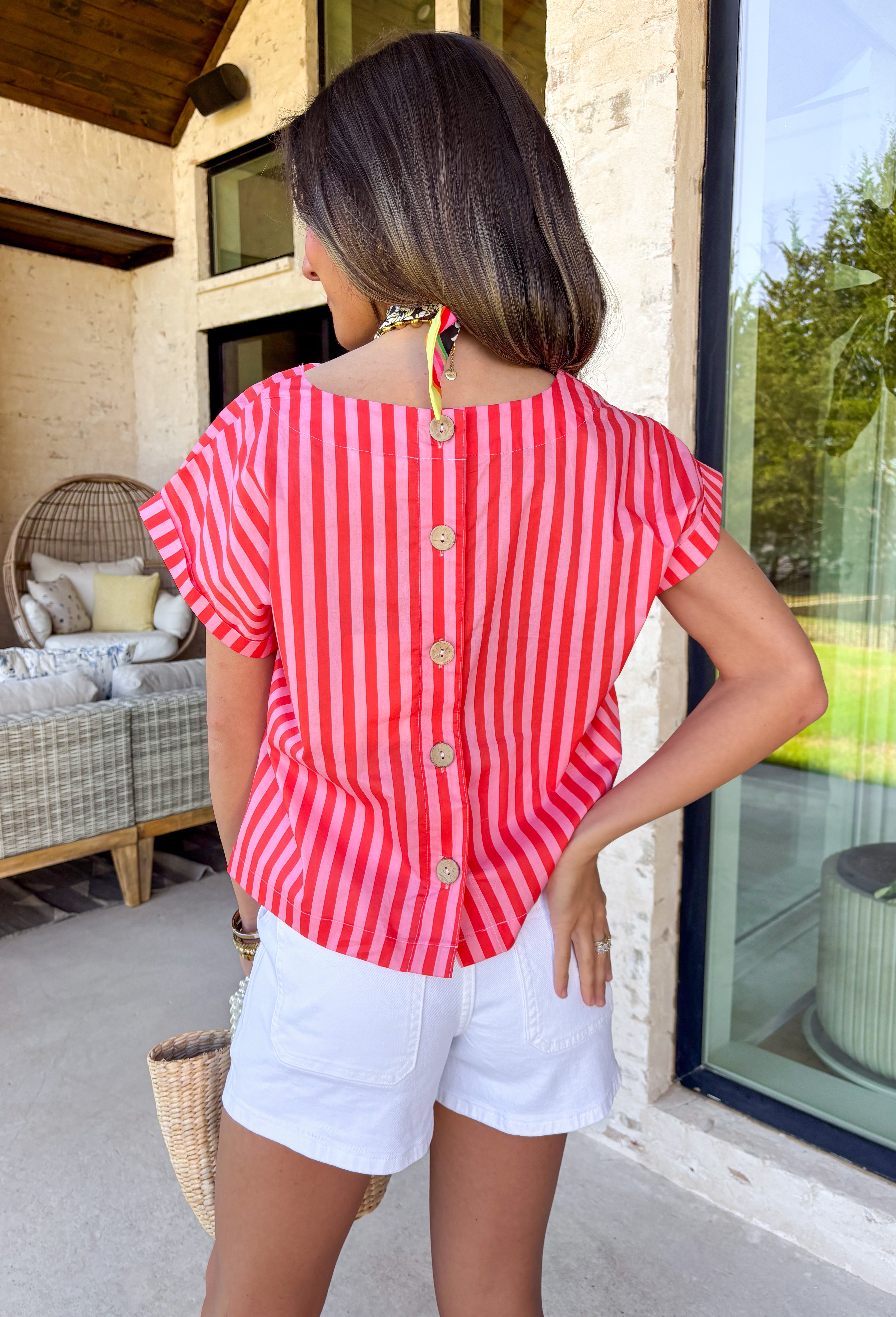 Bright, bold, and made for sunny spring days, this pink and red striped top is the easiest way to add a little fun to your everyday look. The surprise button-down back adds the cutest finishing touch and makes this top feel extra special from every angle—perfect for pairing with denim, white pants, or a flowy skirt. You'll find yourself reaching for this top all season long!