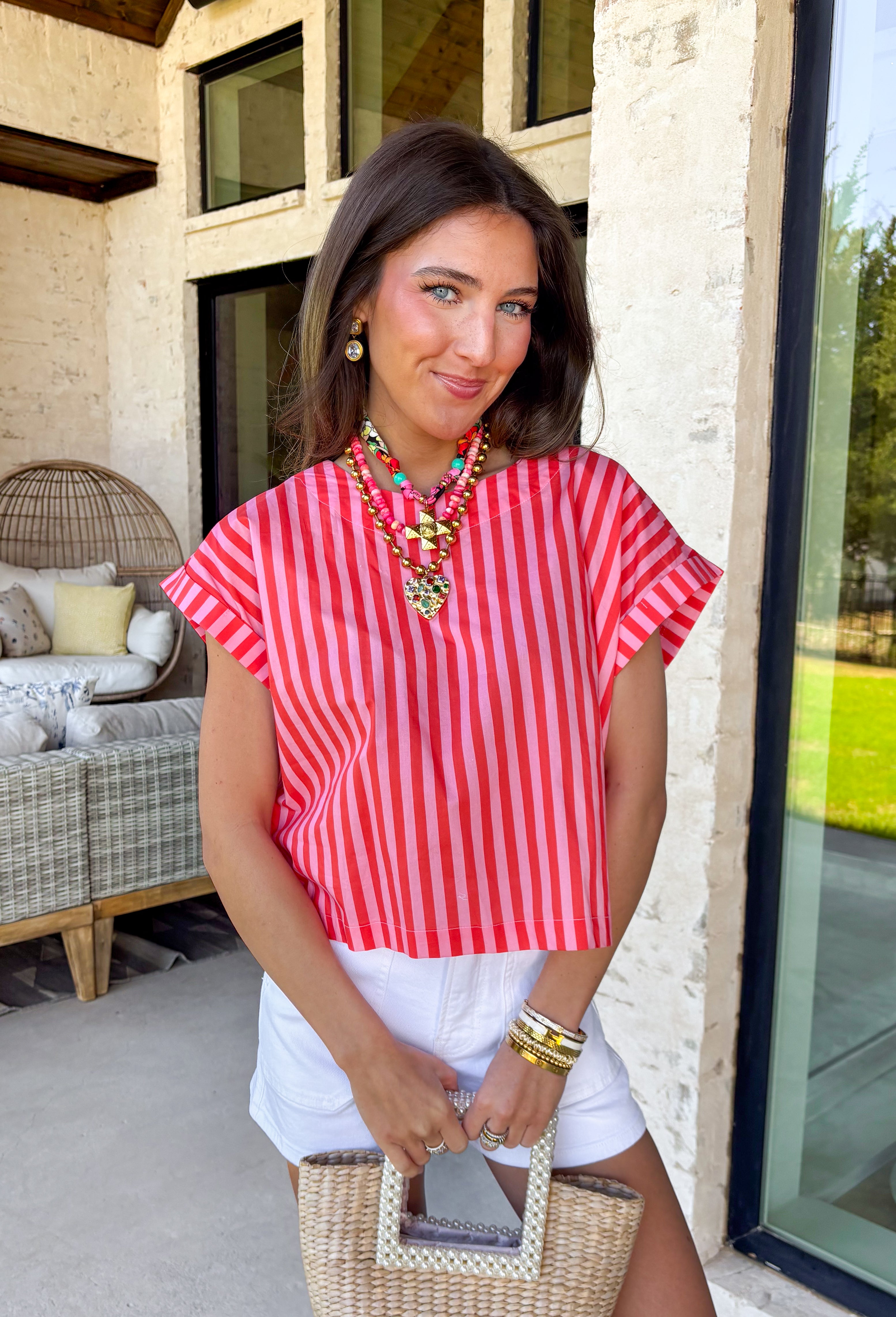 Bright, bold, and made for sunny spring days, this pink and red striped top is the easiest way to add a little fun to your everyday look. The surprise button-down back adds the cutest finishing touch and makes this top feel extra special from every angle—perfect for pairing with denim, white pants, or a flowy skirt. You'll find yourself reaching for this top all season long!