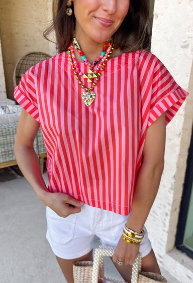 Bright, bold, and made for sunny spring days, this pink and red striped top is the easiest way to add a little fun to your everyday look. The surprise button-down back adds the cutest finishing touch and makes this top feel extra special from every angle—perfect for pairing with denim, white pants, or a flowy skirt. You'll find yourself reaching for this top all season long!