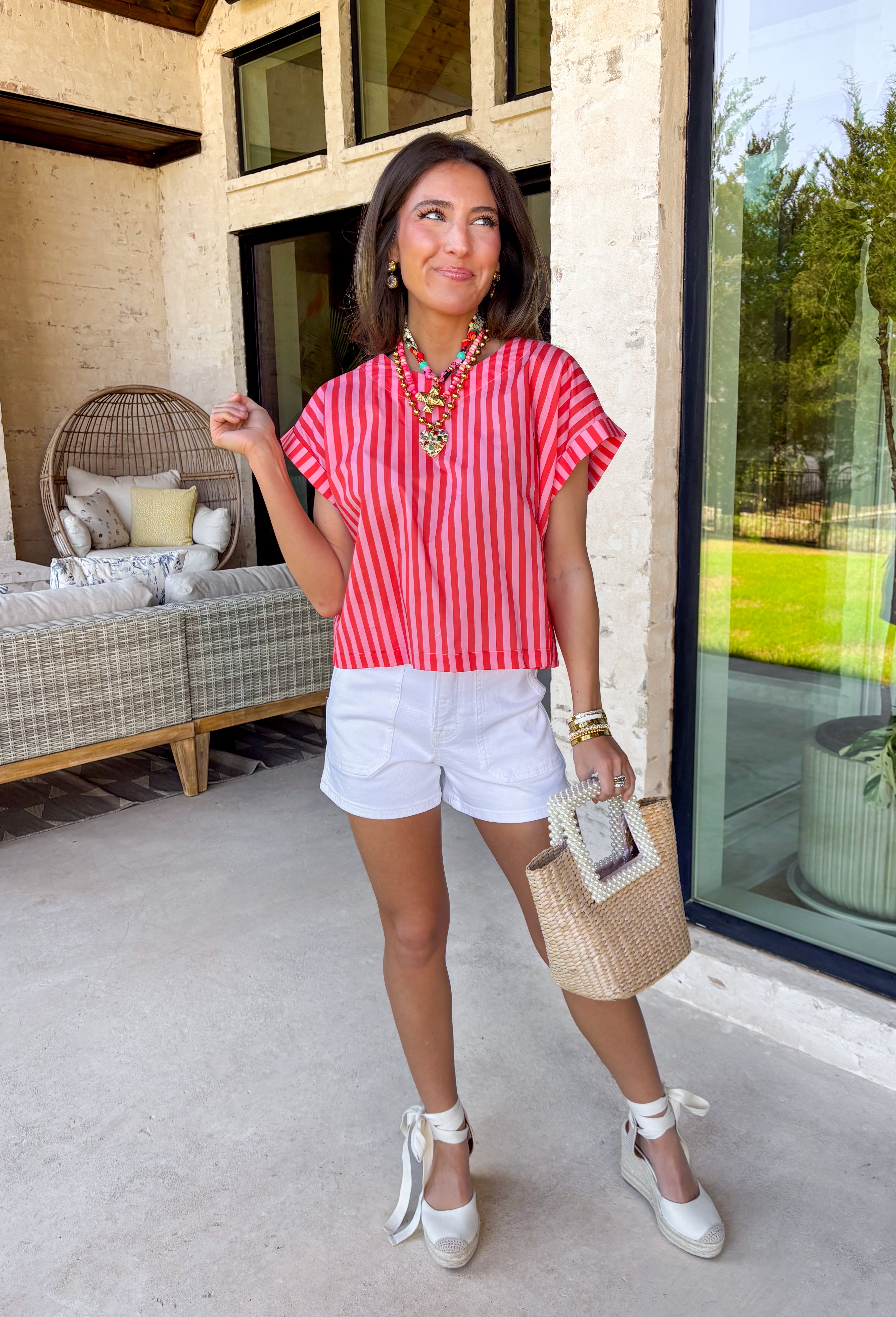 Bright, bold, and made for sunny spring days, this pink and red striped top is the easiest way to add a little fun to your everyday look. The surprise button-down back adds the cutest finishing touch and makes this top feel extra special from every angle—perfect for pairing with denim, white pants, or a flowy skirt. You'll find yourself reaching for this top all season long!