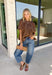 Elevate your fall wardrobe with this stunning faux leather top that perfectly blends edgy style with feminine charm. Designed in a rich chocolate brown, this statement piece features beautiful lace detailing along the front that softens the sleek faux leather finish for a look that's effortlessly sophisticated. The textured fabric adds depth and dimension, while the classic short sleeve silhouette makes it easy to style from season to season. 