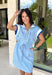 This light blue short sleeve dress is the perfect mix of sporty and cute for summer! Designed with a quarter zip neckline and elastic self-tie waist, it gives you that flattering, adjustable fit while keeping things comfortable for all-day wear. The navy, light blue, and white athletic stripe detail along the front, neckline, and cuffs adds a fun, energetic touch that makes this one stand out. Finished with side pockets (always a win), it’s perfect for everything from errands to casual plans. 