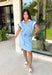 This light blue short sleeve dress is the perfect mix of sporty and cute for summer! Designed with a quarter zip neckline and elastic self-tie waist, it gives you that flattering, adjustable fit while keeping things comfortable for all-day wear. The navy, light blue, and white athletic stripe detail along the front, neckline, and cuffs adds a fun, energetic touch that makes this one stand out. Finished with side pockets (always a win), it’s perfect for everything from errands to casual plans. 
