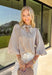Classic stripes meet timeless style in this beautiful button-down blouse you'll reach for season after season. The soft tan and white striped print, feminine tie neckline, and billowy balloon sleeves create an effortlessly polished look that's perfect for the office, weekend brunch, or your favorite fall outings. Pair it with denim for a casual everyday look or tuck it into tailored trousers for an elevated outfit you'll love wearing all autumn long.