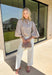 Classic stripes meet timeless style in this beautiful button-down blouse you'll reach for season after season. The soft tan and white striped print, feminine tie neckline, and billowy balloon sleeves create an effortlessly polished look that's perfect for the office, weekend brunch, or your favorite fall outings. Pair it with denim for a casual everyday look or tuck it into tailored trousers for an elevated outfit you'll love wearing all autumn long.