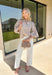 Classic stripes meet timeless style in this beautiful button-down blouse you'll reach for season after season. The soft tan and white striped print, feminine tie neckline, and billowy balloon sleeves create an effortlessly polished look that's perfect for the office, weekend brunch, or your favorite fall outings. Pair it with denim for a casual everyday look or tuck it into tailored trousers for an elevated outfit you'll love wearing all autumn long.