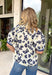 This off white floral top is the perfect transition piece for fall days! The navy floral print with subtle hints of green brings in those rich, seasonal tones while still feeling light and easy to wear. The collared neckline and button down front give it a polished feel, while the navy and white stripe detail along the front and sleeves adds a fun, unexpected touch. Made from breathable cotton, it’s perfect for layering now and wearing into cooler days.