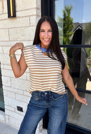 Timeless stripes get a fun seasonal update in this cozy short sleeve sweater. Featuring classic taupe and white stripes with a blue contrast neckline, this knit is the perfect blend of classic and playful. The soft, cozy fabric makes it ideal for crisp fall mornings and cool evenings, while the short sleeves make layering effortless under jackets, and blazers. 