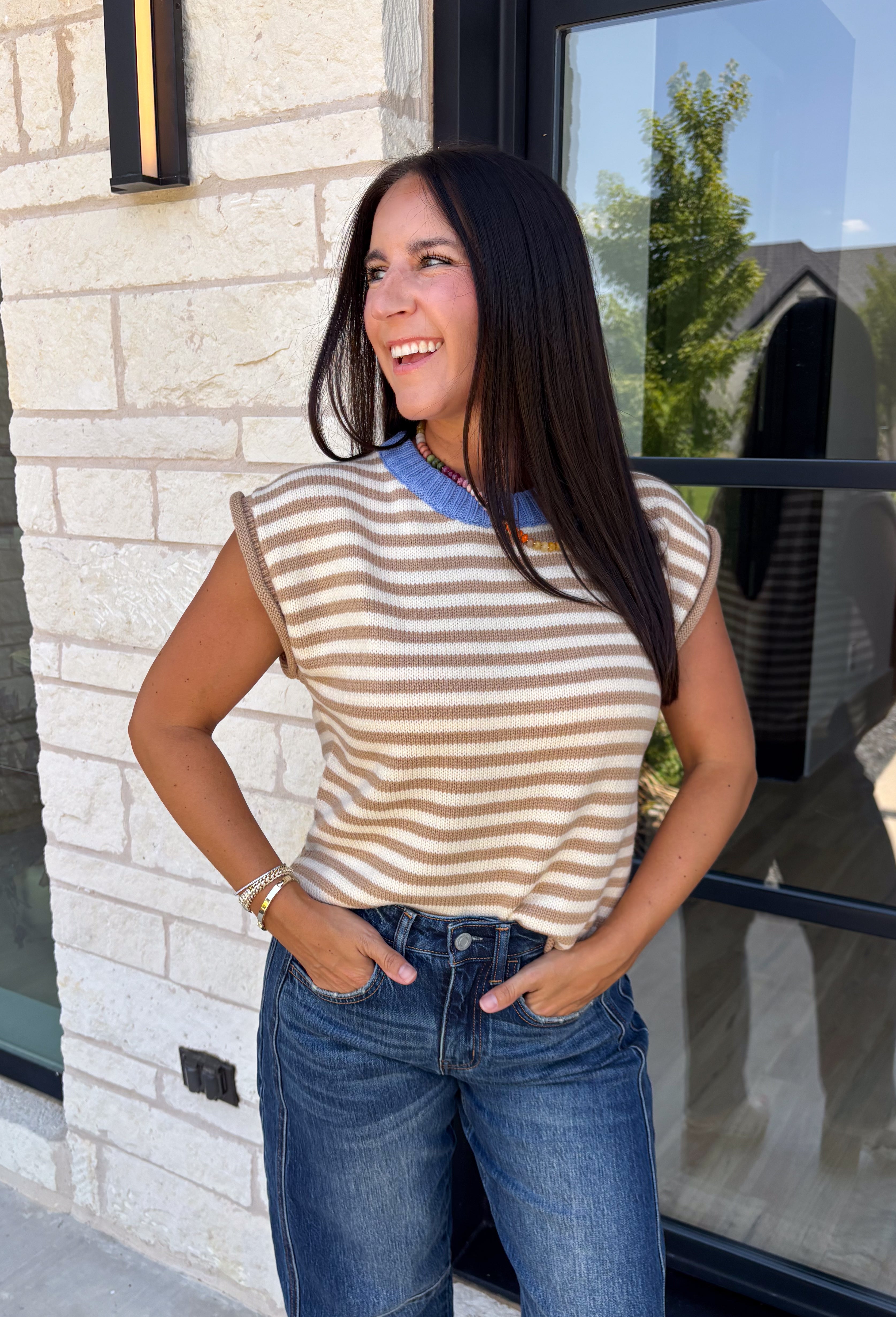 Timeless stripes get a fun seasonal update in this cozy short sleeve sweater. Featuring classic taupe and white stripes with a blue contrast neckline, this knit is the perfect blend of classic and playful. The soft, cozy fabric makes it ideal for crisp fall mornings and cool evenings, while the short sleeves make layering effortless under jackets, and blazers. 