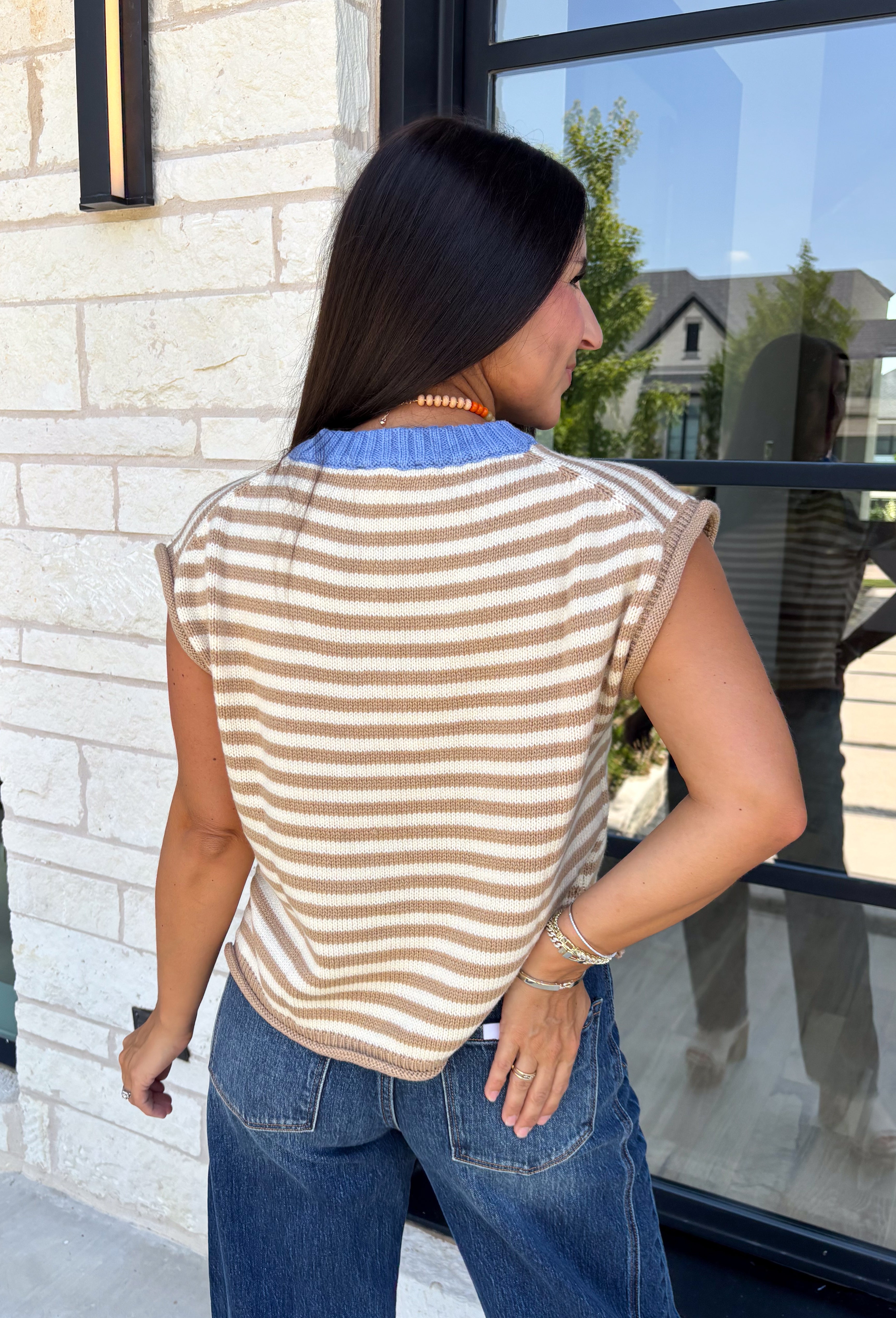 Timeless stripes get a fun seasonal update in this cozy short sleeve sweater. Featuring classic taupe and white stripes with a blue contrast neckline, this knit is the perfect blend of classic and playful. The soft, cozy fabric makes it ideal for crisp fall mornings and cool evenings, while the short sleeves make layering effortless under jackets, and blazers. 