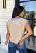 Timeless stripes get a fun seasonal update in this cozy short sleeve sweater. Featuring classic taupe and white stripes with a blue contrast neckline, this knit is the perfect blend of classic and playful. The soft, cozy fabric makes it ideal for crisp fall mornings and cool evenings, while the short sleeves make layering effortless under jackets, and blazers. 