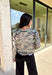Whether you're sipping cider or lounging fireside, this camo cardigan is ready to bring the cozy vibes. It features a soft knit texture, functional button-down front, and just the right touch of edge thanks to the camo print. It's the kind of layer you’ll want to throw on with leggings, jeans, or even over a graphic tee for a relaxed fall look.