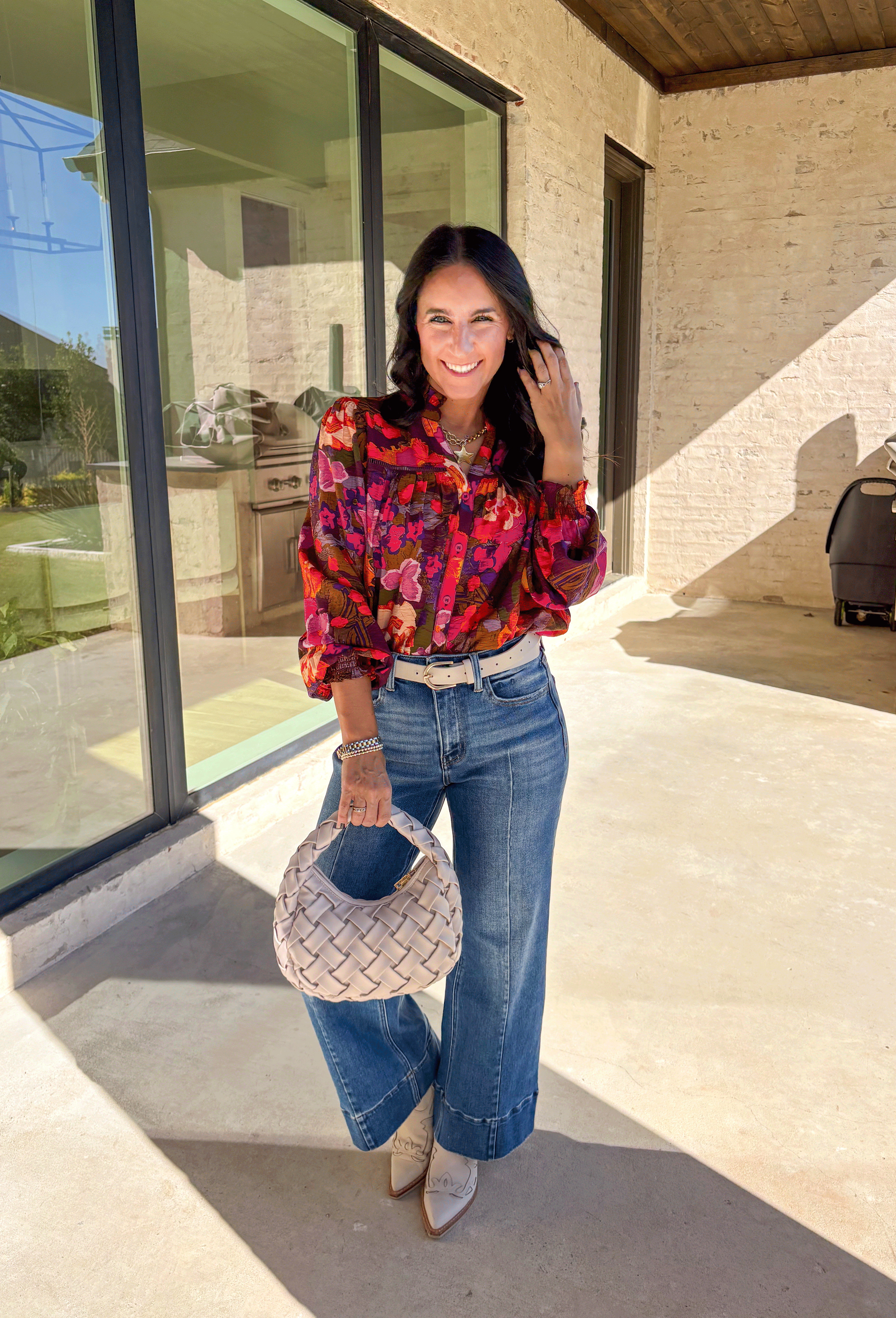 Brighten up your fall wardrobe with this stunning floral print top by Fate. Designed with long sleeves and a subtle ruffle neckline, this piece blends feminine details with bold color. The ladder lace trim across the top adds a touch of texture, while the smocked sleeves bring in a flattering finish. With shades of orange, purple, and pink throughout, this top perfectly balances playful color and everyday sophistication.