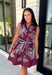 Rich fall colors and beautiful embroidered details make this dress an instant seasonal favorite! Crafted in a gorgeous wine hue, this sleeveless dress features delicate light blue and off white floral embroidery that creates a charming, handcrafted look. The button front and self-tie waist belt with playful contrast pom trim create a flattering silhouette, while side pockets and a fully lined design make it as practical as it is beautiful. 
