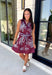 Rich fall colors and beautiful embroidered details make this dress an instant seasonal favorite! Crafted in a gorgeous wine hue, this sleeveless dress features delicate light blue and off white floral embroidery that creates a charming, handcrafted look. The button front and self-tie waist belt with playful contrast pom trim create a flattering silhouette, while side pockets and a fully lined design make it as practical as it is beautiful. 