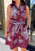 Rich fall colors and beautiful embroidered details make this dress an instant seasonal favorite! Crafted in a gorgeous wine hue, this sleeveless dress features delicate light blue and off white floral embroidery that creates a charming, handcrafted look. The button front and self-tie waist belt with playful contrast pom trim create a flattering silhouette, while side pockets and a fully lined design make it as practical as it is beautiful. 