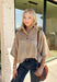 Classic stripes and cozy comfort come together in this effortlessly stylish sweater from Entro. Designed in a warm camel hue with timeless off-white stripes, this short sleeve sweater is the perfect blend of polished and comfortable. The mock neckline gives it a sophisticated touch, while the decorative button detail at the front adds just the right amount of charm. Finished with ribbed trim and a soft, cozy knit, this versatile top is perfect for everything from workdays to weekend coffee dates.