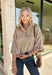 Classic stripes and cozy comfort come together in this effortlessly stylish sweater from Entro. Designed in a warm camel hue with timeless off-white stripes, this short sleeve sweater is the perfect blend of polished and comfortable. The mock neckline gives it a sophisticated touch, while the decorative button detail at the front adds just the right amount of charm. Finished with ribbed trim and a soft, cozy knit, this versatile top is perfect for everything from workdays to weekend coffee dates.