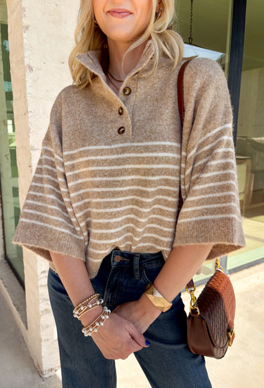 Classic stripes and cozy comfort come together in this effortlessly stylish sweater from Entro. Designed in a warm camel hue with timeless off-white stripes, this short sleeve sweater is the perfect blend of polished and comfortable. The mock neckline gives it a sophisticated touch, while the decorative button detail at the front adds just the right amount of charm. Finished with ribbed trim and a soft, cozy knit, this versatile top is perfect for everything from workdays to weekend coffee dates.