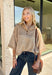 Classic stripes and cozy comfort come together in this effortlessly stylish sweater from Entro. Designed in a warm camel hue with timeless off-white stripes, this short sleeve sweater is the perfect blend of polished and comfortable. The mock neckline gives it a sophisticated touch, while the decorative button detail at the front adds just the right amount of charm. Finished with ribbed trim and a soft, cozy knit, this versatile top is perfect for everything from workdays to weekend coffee dates.