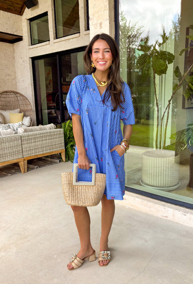 This short sleeve blue dress by Entro is the perfect mix of classic stripes and sweet spring details. Featuring a crisp white stripe print throughout, it’s bright, timeless, and easy to wear—but the embroidered floral design takes it to the next level. With pops of pink, blue, and green stitched throughout, it has that extra-special feel while still being totally everyday-friendly. The fit is comfortable and effortless, plus it’s fully lined for easy wear and confidence.