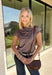 Add a fresh take on classic fall plaid to your wardrobe with this brown micro plaid top from Current Air. The draped cowl neckline creates a soft gathered effect that gives the silhouette a little extra interest without feeling overdone. A ribbed backing adds an unexpected mix of texture, while the warm brown plaid makes it easy to pair with all your favorite autumn neutrals. Wear it with trousers for a put-together office look, then swap in denim and boots when the weekend rolls around.