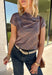 Add a fresh take on classic fall plaid to your wardrobe with this brown micro plaid top from Current Air. The draped cowl neckline creates a soft gathered effect that gives the silhouette a little extra interest without feeling overdone. A ribbed backing adds an unexpected mix of texture, while the warm brown plaid makes it easy to pair with all your favorite autumn neutrals. Wear it with trousers for a put-together office look, then swap in denim and boots when the weekend rolls around.