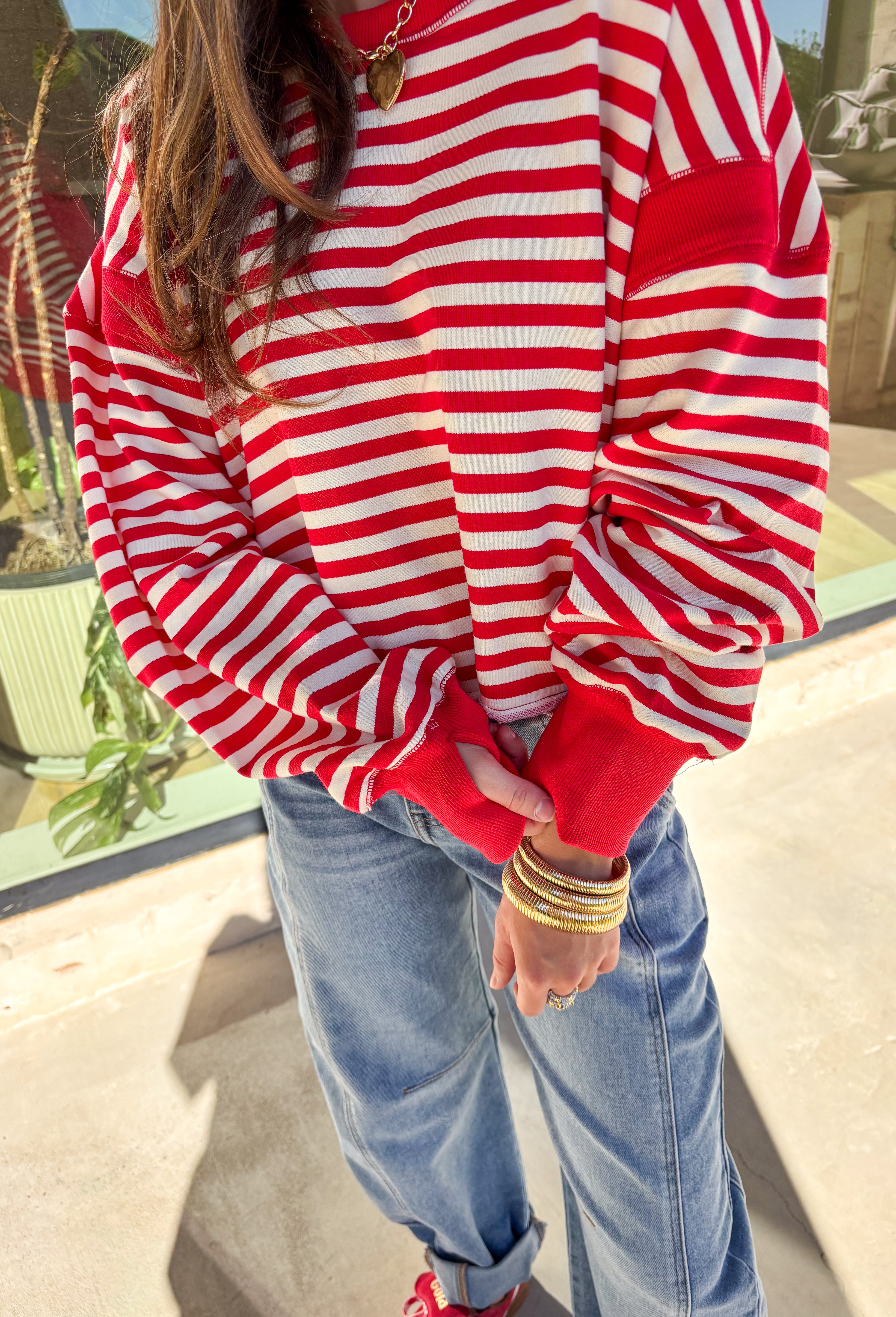 A classic stripe with a flirty twist—this red and ivory long sleeve top by Rae Mode is perfect for cozy yet stylish days. The open-back design adds a fun surprise, while the solid red detailing on the cuffs, sleeve centers, and neckline gives it a bold pop. Crafted from a soft, stretchy fabric blend, it’s the ultimate mix of comfort and statement style for the season.