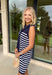 Polished with a playful twist! This navy sleeveless dress features a timeless white stripe print and a unique knit scarf tie detail at the neckline that instantly elevates the look. It’s classic, but with just enough personality to stand out. The sleeveless silhouette keeps it sleek and versatile, while the soft knit fabric offers a comfortable, flattering drape. Whether you’re heading to brunch, the office, or a weekend getaway, this dress makes getting dressed feel effortless and put-together.