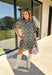 Embrace the beauty of the season in this charming dress from Entro. Featuring a gorgeous floral print in shades of hunter green, muted green, peach, and brown, this feminine dress is perfect for everything from weekend brunches to seasonal celebrations. The button-front design and flattering neckline create a timeless silhouette, while the ¾ puff sleeves with delicate tie details add a playful touch. 