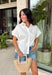 This white ruffle sleeve top is such an effortlessly polished piece for summer! The pearl trim detail adds the prettiest, elevated touch, while the ruffle sleeves bring in a soft, feminine feel. Designed with a classic collared neckline and button front, it’s the perfect mix of timeless and fresh. Lightweight with a hint of stretch, it’s comfortable enough for all-day wear while still looking put together. Whether you're heading to work, brunch, or a casual dinner, this top makes styling so easy. 