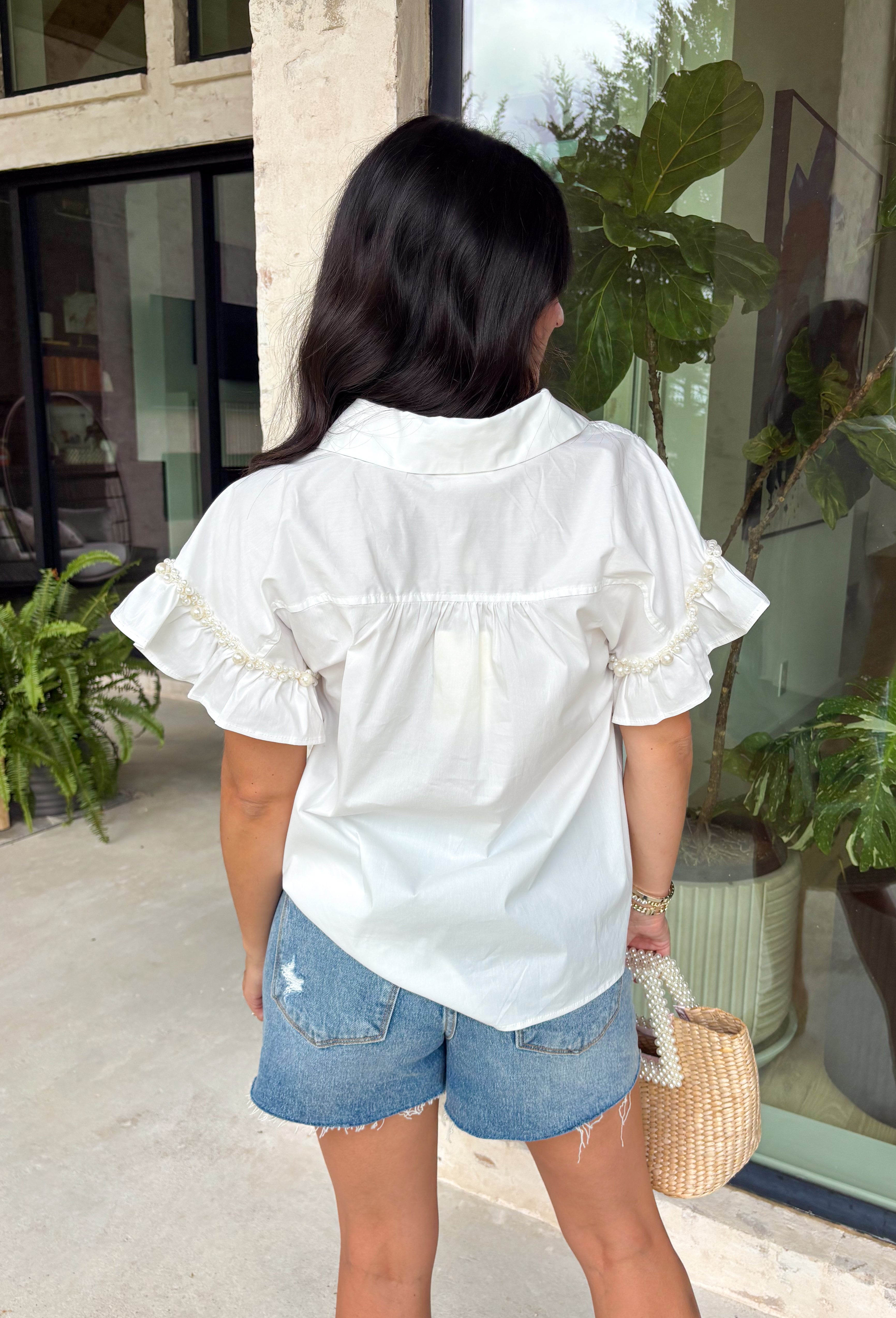 This white ruffle sleeve top is such an effortlessly polished piece for summer! The pearl trim detail adds the prettiest, elevated touch, while the ruffle sleeves bring in a soft, feminine feel. Designed with a classic collared neckline and button front, it’s the perfect mix of timeless and fresh. Lightweight with a hint of stretch, it’s comfortable enough for all-day wear while still looking put together. Whether you're heading to work, brunch, or a casual dinner, this top makes styling so easy. 