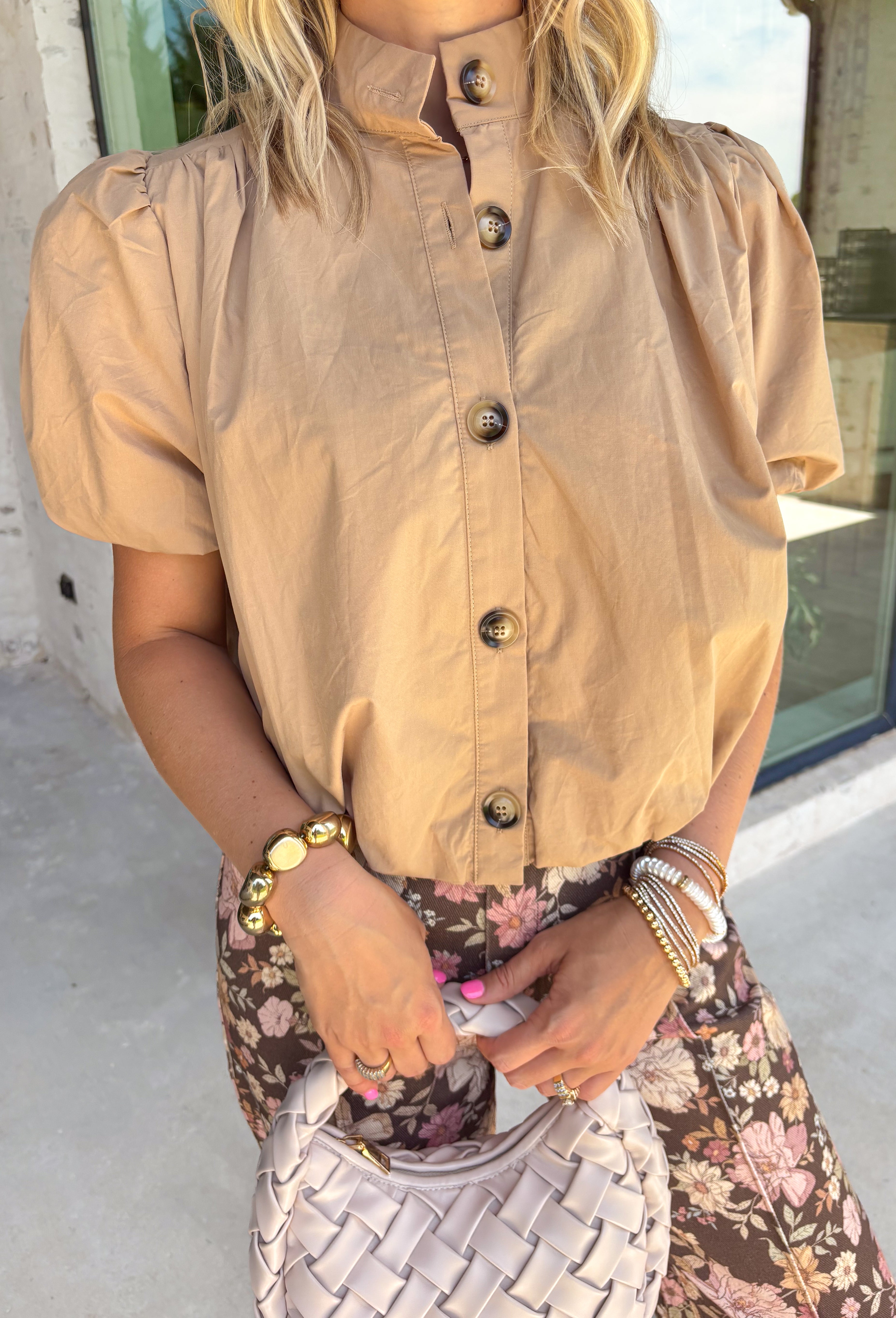 Simple, polished, and effortlessly chic, this tan button down top is a staple you'll wear all fall long. Crafted from breathable cotton, this timeless top features a modern bubble hem that creates a flattering silhouette with little effort. The band collar and button front add a tailored touch, while the short puff sleeves bring just the right amount of feminine charm. 