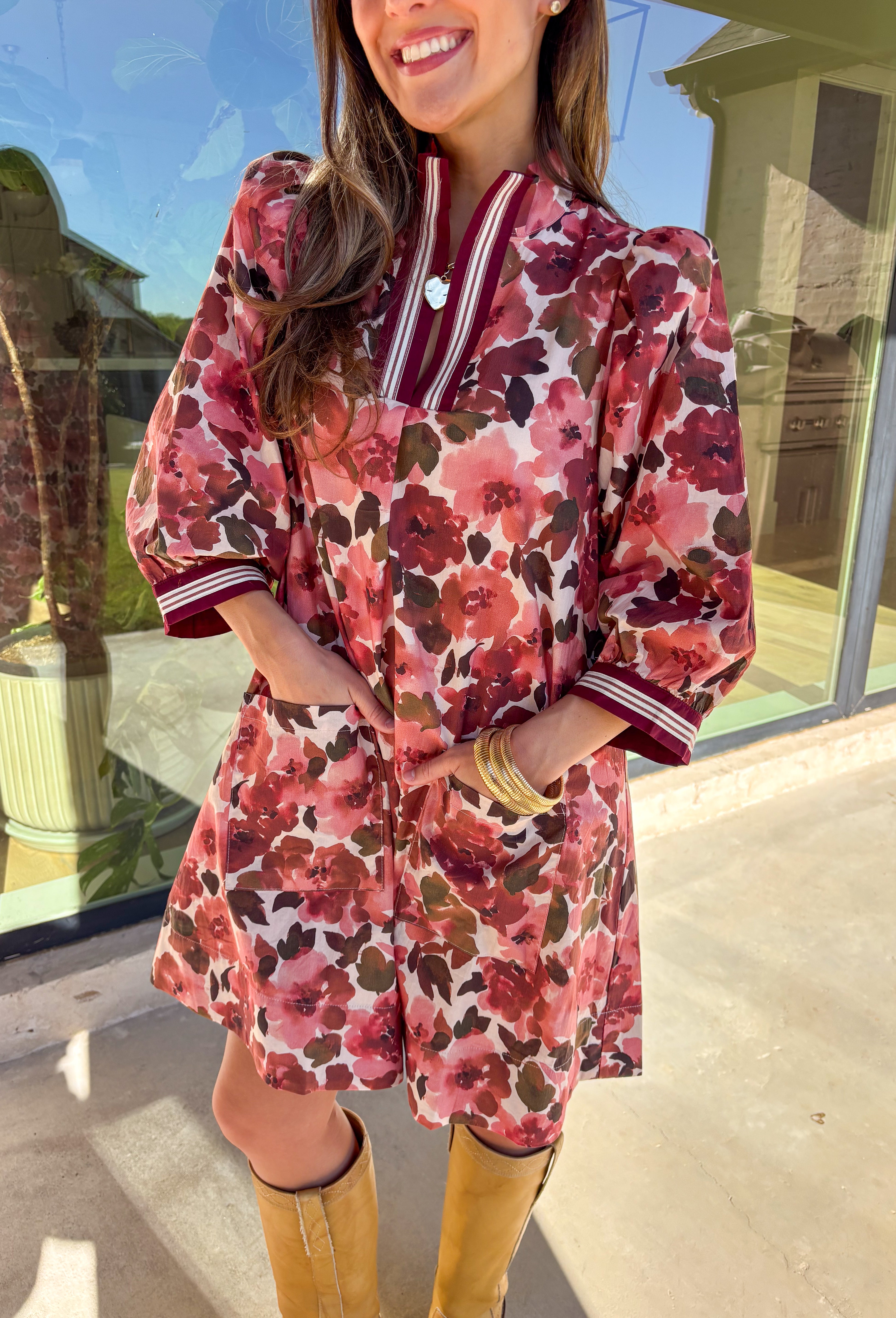 This floral dress by Entro is the perfect mix of playful and polished. Designed in rich shades of wine, it features puff sleeves and a striped trim collar and cuffs that add a sporty yet feminine touch. The patch pockets at the front bring in a bit of practicality, while the soft cotton fabric and full lining keep it comfortable and easy to wear. A fun fall piece that transitions seamlessly from weekday wear to weekend outings.