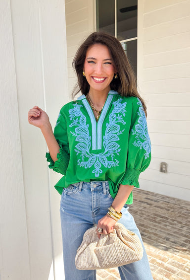 Simple with a special touch, this green ¾ sleeve top by Entro is an easy spring staple you’ll wear on repeat. Designed with a split v-neckline and contrast binding detail, it feels polished yet relaxed. Blue embroidered accents add just the right pop of color, giving the top a fresh, handcrafted feel. Finished with elasticated cuffs for comfort and shape, this piece pairs effortlessly with denim, trousers, or skirts for everyday spring style.