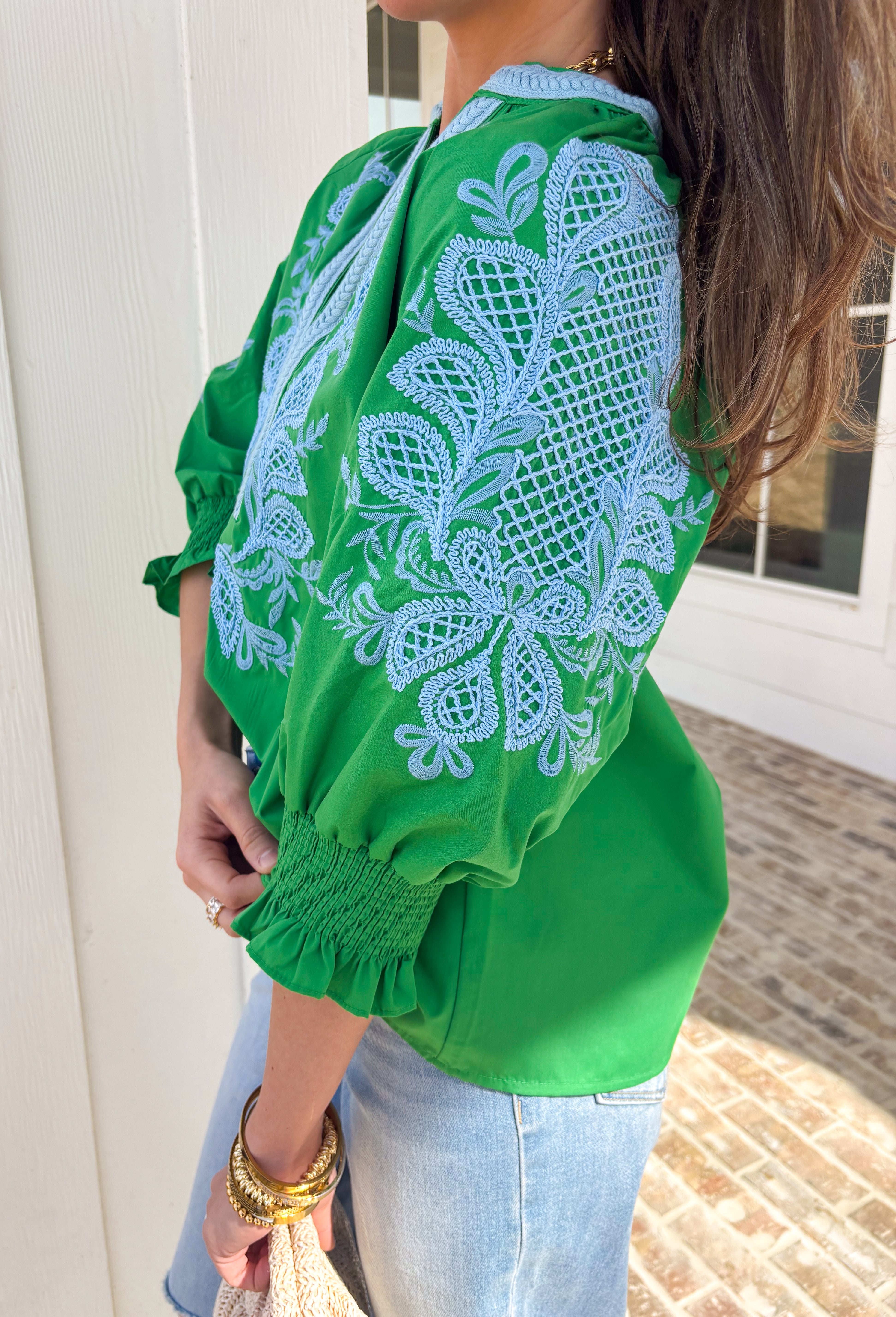 Simple with a special touch, this green ¾ sleeve top by Entro is an easy spring staple you’ll wear on repeat. Designed with a split v-neckline and contrast binding detail, it feels polished yet relaxed. Blue embroidered accents add just the right pop of color, giving the top a fresh, handcrafted feel. Finished with elasticated cuffs for comfort and shape, this piece pairs effortlessly with denim, trousers, or skirts for everyday spring style.