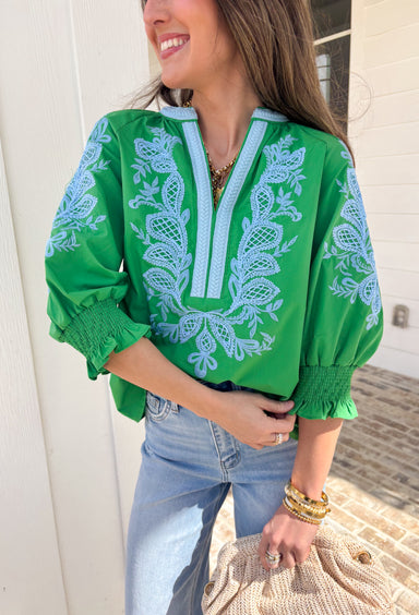 Simple with a special touch, this green ¾ sleeve top by Entro is an easy spring staple you’ll wear on repeat. Designed with a split v-neckline and contrast binding detail, it feels polished yet relaxed. Blue embroidered accents add just the right pop of color, giving the top a fresh, handcrafted feel. Finished with elasticated cuffs for comfort and shape, this piece pairs effortlessly with denim, trousers, or skirts for everyday spring style.