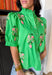 Bright, cheerful, and full of spring charm, this kelly green short sleeve top by Entro is such a fun way to add a pop of color to your everyday lineup. The pink and green floral embroidery along the top gives it that extra-special touch, while the button-down front keeps it classic and easy to style. Finished with puff sleeves and a sweet ruffle neckline, this top feels feminine and playful without being too fussy.